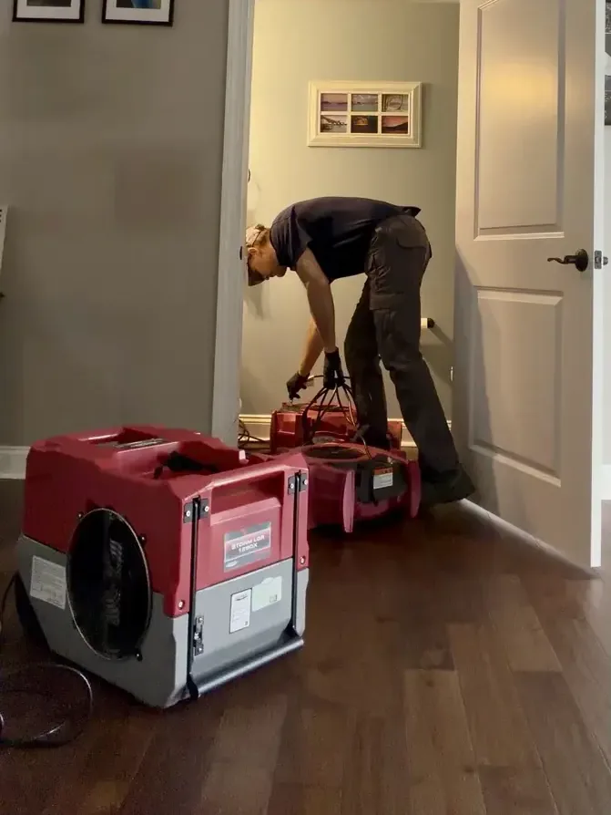 Crew shoveling silt from a garage floor